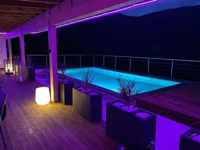 a swimming pool lit up at night with purple lights at Olden Studioapartment in Olden