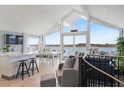 a kitchen and living room with a boat on the wall at Atlantic Panorama in Vevang