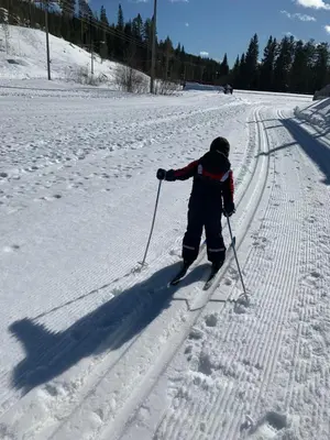 a child is cross country skiing in the snow at In the middle of Trysil fjellet - Welcome Center - Apartment with 4 bedrooms and sauna - By bike arena and ski lift in Trysil