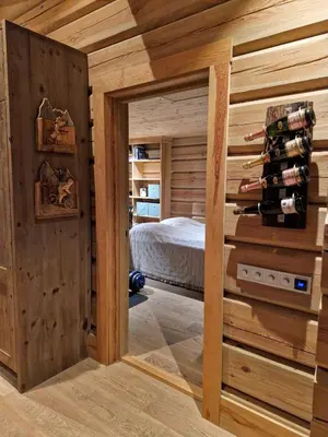 a room with a bed and a room with wooden walls at Liaplassen Timber Lodge in Beitostøl