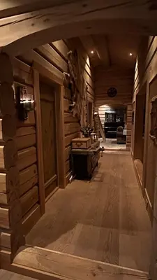 a hallway in a log cabin with wooden walls at Liaplassen Timber Lodge in Beitostøl