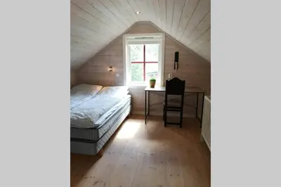 a bedroom with a bed and a desk in a attic at Casa Kleiv i Sogndalsdalen in Sogndal