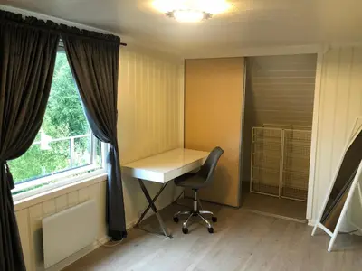 an office with a desk and a chair in front of a window at Atlantic Panorama Villa Kalle in Kristiansund