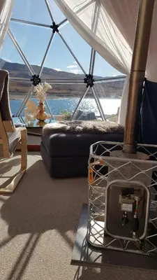 a room with a tent with a view of the ocean at Jotunheimen Arctic Domes in Beitostøl