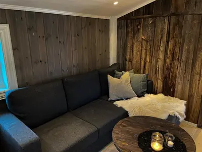 a living room with a couch and a table at Stall-loftet, Aastrøen gård, Vingelen in Vingelen
