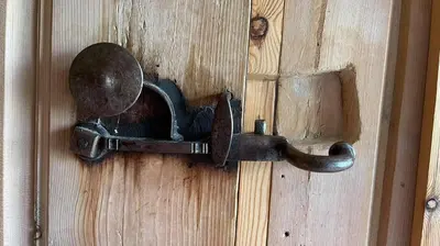 an old iron door knocker on a wooden door at Gammelstua ved Femund in Elga