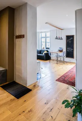 a living room with wooden floors and a dining room at Cozy apartment in Alesund city in Ålesund