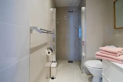 a bathroom with a shower and a toilet at Cozy apartment in Alesund city in Ålesund