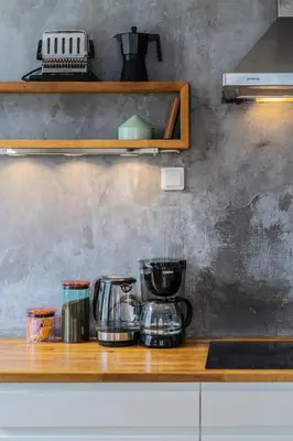 a counter top with a coffee maker and appliances on it at Cozy apartment in Alesund city in Ålesund