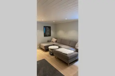 a living room with a couch and a table at Townhouse with fantastic outdoor area in Trondheim