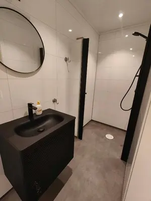 a bathroom with a black sink and a mirror at Gjøa Motell in Rosendal
