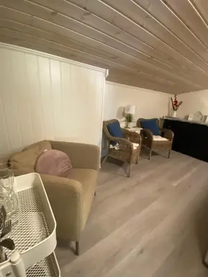 a living room with a couch and chairs at Kvamseter Lodge private family apartment in Kvam