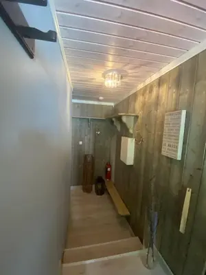 a long hallway with stairs in a building at Kvamseter Lodge private family apartment in Kvam