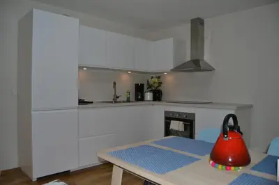 a kitchen with a red tea kettle on a table at Totally independent apartment near NTNU,Lerkendal and Center in Trondheim