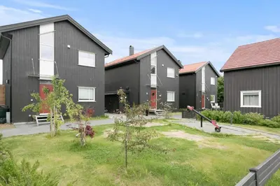 a row of houses with a garden in a yard at Totally independent apartment near NTNU,Lerkendal and Center in Trondheim