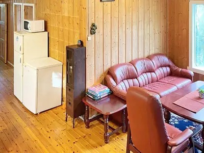 a living room with a leather couch and a table at 4 person holiday home in Reksteren-By Traum in Klinkholmen