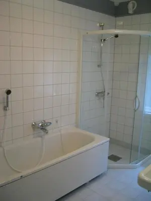 a bathroom with a bath tub and a shower at Hjelle Hotel in Hjelle