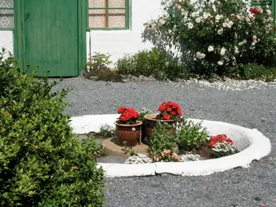 two potted plants sitting in a circle in a yard at Hjelle Hotel in Hjelle