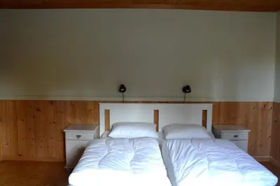 a bedroom with a bed with two white pillows at Fulufjellet nationalpark Lodge - Home of snow, nature and peace in Ljørdalen