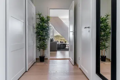 a hallway with potted plants and a mirror at MJOS TOWER Apartment - Lovely city view in Ringsaker