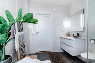a bathroom with a toilet and a sink at MJOS TOWER Apartment - Lovely city view in Ringsaker
