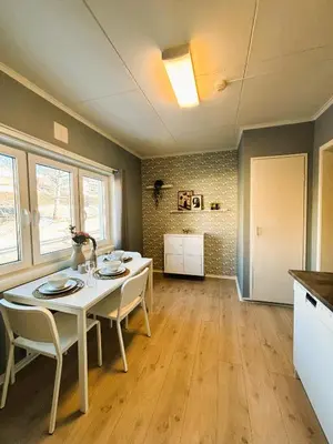 a kitchen and dining room with a white table and chairs at Lillehammer Camping - Sentrums leilighet in Lillehammer