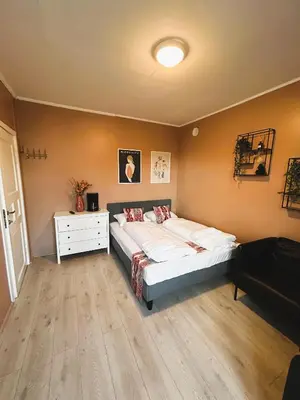a bedroom with a large bed and a white dresser at Lillehammer Camping - Sentrums leilighet in Lillehammer