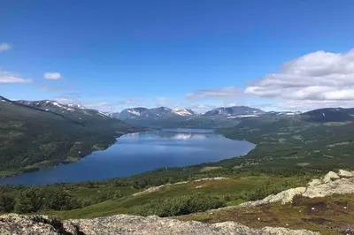 a view of a lake in a valley with mountains at Fjellro Mountain Cabin in Oppdal