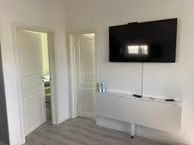 a room with a flat screen tv on a wall at Feriehus med Sjøutsikt in Sætra