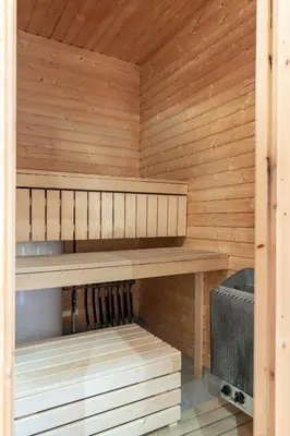 a sauna with wooden walls and a wooden bench at Skiers Lodge 2 - Saga Apartments in Hemsedal