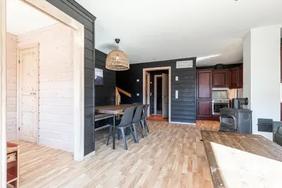 a kitchen and dining room with a table and chairs at Skiers Lodge 2 - Saga Apartments in Hemsedal