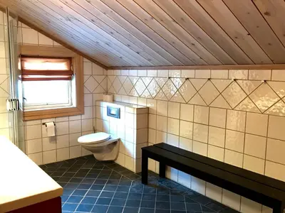 a bathroom with a toilet and a window at Kirkebøen Hytter in Hemsedal