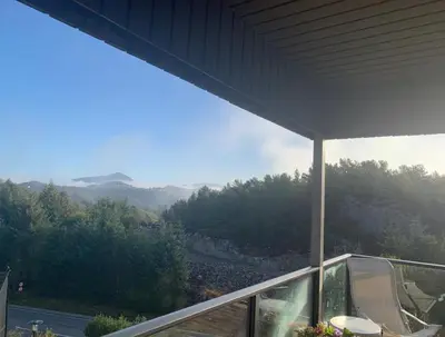a balcony with a view of a mountain at Villa with jacuzzi in Nord Bjørøy