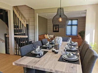 a dining room with a long table and chairs at Godo Lodge in Godøy