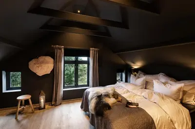 a bedroom with a bed with a dog laying on it at Godo Lodge in Godøy