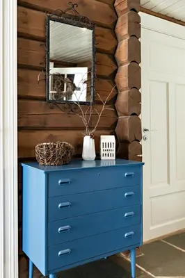 a blue dresser with a mirror on a wall at Utsikten in Sykkylven