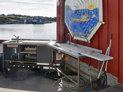 a sink on the side of a boat with a painting at 6 person holiday home in Bud-By Traum in Bud