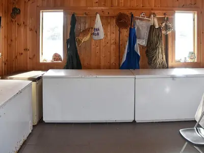a kitchen with white cabinets and two windows at 6 person holiday home in Bud-By Traum in Bud