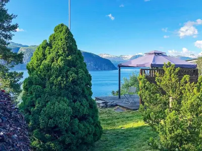 a view of a lake from a house with a gazebo at 6 person holiday home in Utvik in Utvik