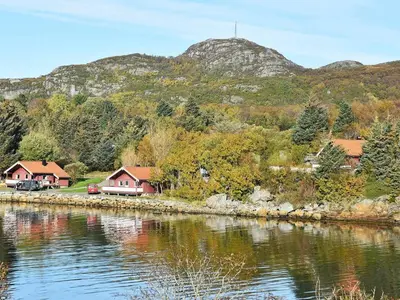a lake with houses and a mountain in the background at 6 person holiday home in Bud-By Traum in Bud