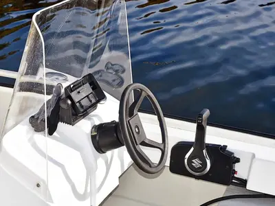 a steering wheel on a boat in the water at 6 person holiday home in Bud-By Traum in Bud