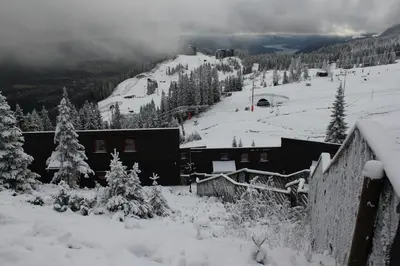 a snow covered mountain with a ski lodge and trees at Kvitfjell Alpinhytter Kvitfjellvegen 492 in Kvitfjell