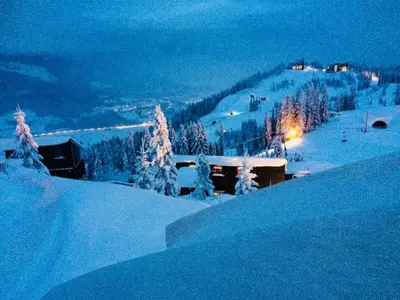 a snow covered hill with a house in the snow at Kvitfjell Alpinhytter Kvitfjellvegen 492 in Kvitfjell