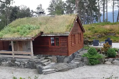 a small log cabin with a grass roof at Klævold utleigehytte in Klevoll