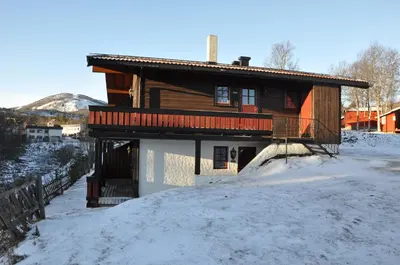 a house on a hill with snow on the ground at Øen Turistsenter Apartments in Geilo