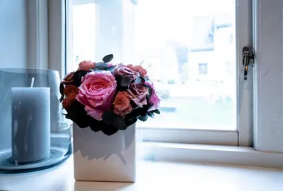 a bouquet of flowers in a vase next to a candle at Trolltunga Living in Tysso