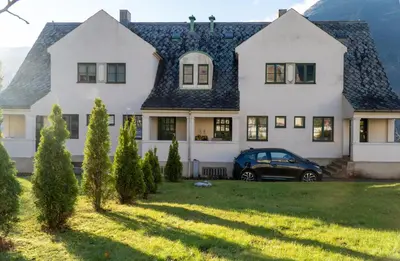 a house with a car parked in front of it at Trolltunga Living in Tysso