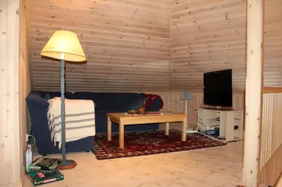 a living room with a couch and a table with a lamp at Magnesplass - Dagalifjell in Dagali