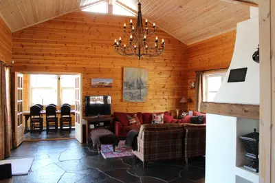 a living room with a couch and a tv at Magnesplass - Dagalifjell in Dagali