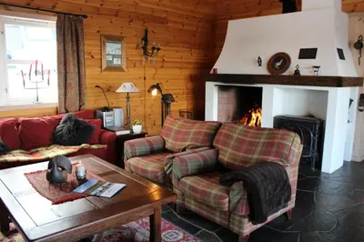 a living room with a couch and a fireplace at Magnesplass - Dagalifjell in Dagali